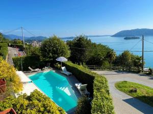 a swimming pool with a view of the water at Pellegrini Boutique Villa Lake View in Verbania