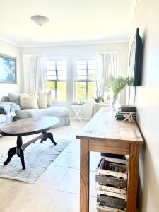 a living room with a table and a couch at Elysian Retreat in Ballito