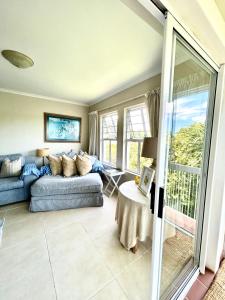 a living room with a couch and a table at Elysian Retreat in Ballito