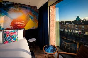 A bed or beds in a room at NYX Hotel Dublin Portobello