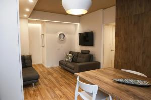 a living room with a table and a couch at Suite Strasburgo in Palermo