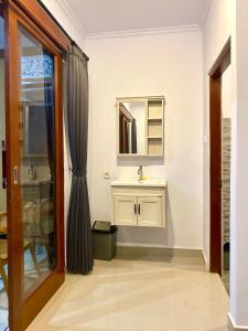a bathroom with a sink and a mirror at Tirta Kemala House in Ubud +22 photos