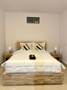 A bed or beds in a room at Tirta Kemala House