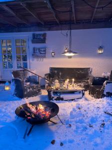 a fire pit in the snow in a living room at Grethelund - 50m2 in Silkeborg