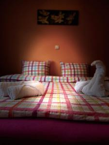 a bed with a stuffed animal sitting on top of it at Penzion Chaloupka in Prague