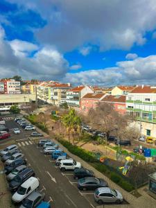 a parking lot filled with parked cars in a city at Lisbon Luxury Studio in Amadora