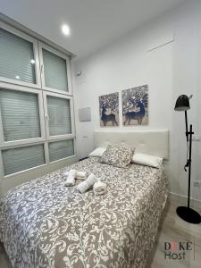 a bedroom with a bed with two towels on it at Alfonso XIII Apartments 2 in Madrid