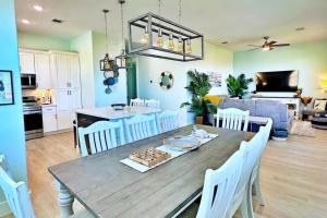 a dining room and living room with a table and chairs at Beach Please in Surfside Beach