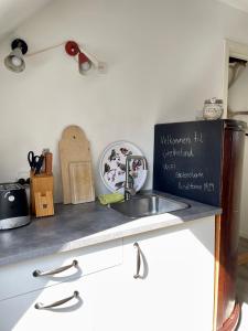 a kitchen counter top with a sink and a counter top at Grethelund - 50m2 in Silkeborg