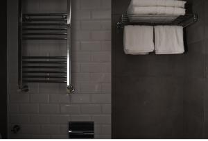 a bathroom with white towels hanging on a rack at Avenue Luxury Apartments in Alexandroupoli