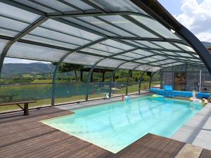 a large swimming pool with a glass roof at villa colticciola Agriturismo Marche in Cagli