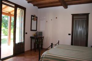 Postel nebo postele na pokoji v ubytování Agriturismo Il Rustico