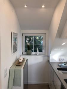 a kitchen with a table and a window at Schicke Landhauswohnung mit Dachterrasse in Königswinter