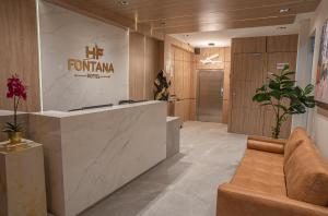 a lobby with a reception desk in a building at Hotel Fontana Bogotá - Corferias in Bogotá