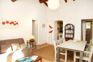 a living room with a couch and a table at Villa Tizzano, Santa Giulia in Porto-Vecchio