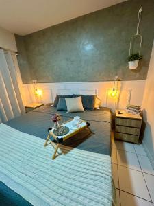 a bedroom with two beds with a table on it at Apartamento completo e encantador in Ribeirão Preto