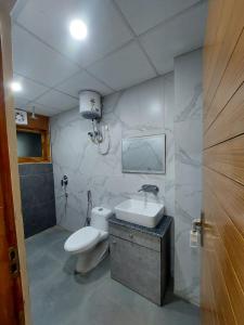 a bathroom with a toilet and a sink at Hotel Green Lotus By Dsy Hospitality in Noida