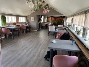 um restaurante com mesas e cadeiras num quarto em Hotel Strandgaarden em Vesterø Havn