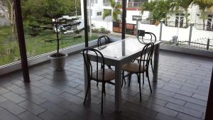 a table and chairs on a patio with a window at Villa FRANCOISE in Pereybere