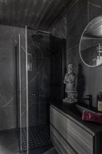 a bathroom with a shower and a sink at Luxurious Mountain Lodge in Ljørdal