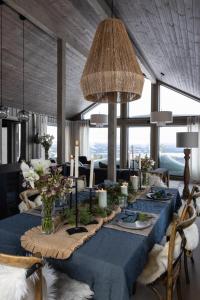 un comedor con una mesa azul con flores y velas en Luxurious Mountain Lodge en Ljørdal