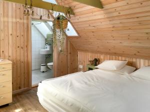 a bedroom with wooden walls and a bed in a room at Hotel Strandgaarden in Vesterø Havn