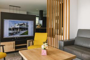 a living room with a couch and a tv at Villa Boiky - private pool and amazing sea view, Istria in Materada