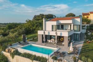an aerial view of a villa with a swimming pool at Villa Boiky - private pool and amazing sea view, Istria in Materada