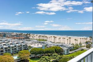 a view of a beach with palm trees and condos at Stunning Top floor 2BD 2BA Ocean View Santa Monica in Los Angeles