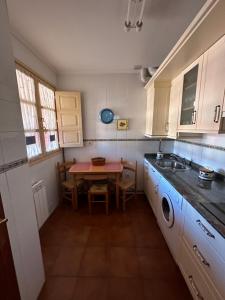 a small kitchen with a table and a sink at Apartamento Las Martas in Comillas