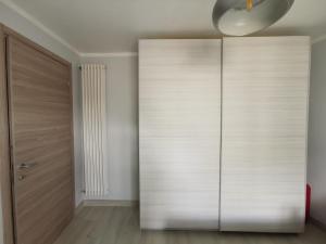 a room with a large wooden closet with a door at Casa Leopoldo in Ceva