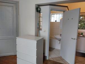 a bathroom with a white cabinet and a sink at Cosy Studio in Brussels