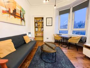 a living room with a couch and a table at Central Edinburgh, Quirky & Modern 1 bed apartment in Edinburgh