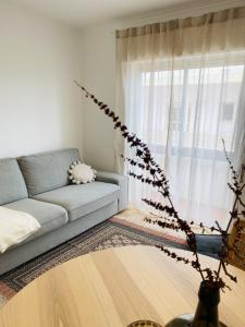 a living room with a couch and a window at Bright modern 3 BR in Portimao downtown in Portimão