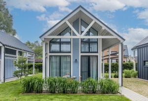 a house with a greenhouse in a yard at 6_banga in Palanga