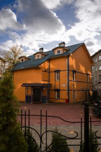a large brown building with a black roof at Best apartments Narva in Narva
