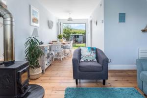 a living room with a chair and a stove at Wooda Farm Holidays in Bude