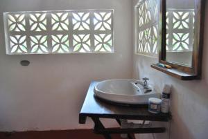 un bagno con lavandino e specchio di PRIVATE BEACH BUNGALOW ZERO MINUTE to beach Matemwe a Gazija Altre 40 foto
