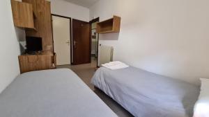 Postel nebo postele na pokoji v ubytování Albergo Meublé Aurora