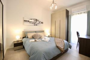 a bedroom with a bed with two towels on it at Gzira 3 bedroom apartment in Il-Gżira