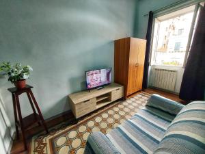 a living room with a couch and a tv at La Casa del Moro - All' Operà in Palermo