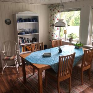 a dining room with a blue table and chairs at Bergsviksvägen 5, Munkedal in Munkedal