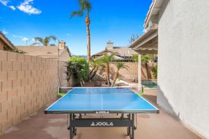 a ping pong table in the backyard of a house at The Modern Indio Large Family Home With Pool And Spa in Indio