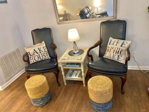 two chairs and a table with a lamp and a pillow at Smooth Sailing on Lake Waccamaw in Lake Waccamaw
