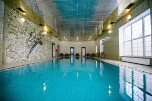 a large swimming pool with a person jumping in the air at Olympic Sport in Podgortsy