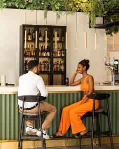 a man and a woman sitting at a bar at The Gate London City in London