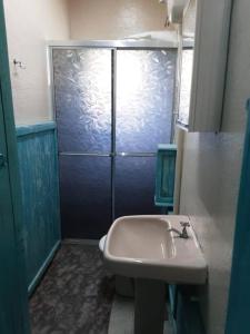 a bathroom with a toilet and a sink and a shower at Chácara Spring Feston in Mairinque