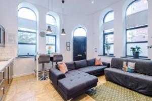 a living room with a couch and a table at Gorgeous Central Flat - Perfect Corporate Stay by PureStay Short Lets in Leeds