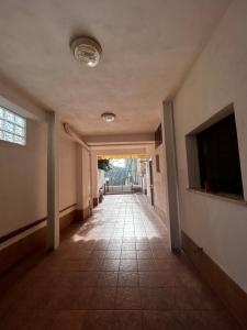 an empty hallway with a flat screen tv and a flat screen tv at B&B al Centro del Borgo in Custonaci