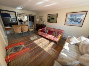 a living room with a couch and a table at Central Georgian Garden Flat with Free Parking in Bath